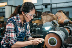 Female Worker Holding Components Metal Grinding 835676872 7360x4912 (1)