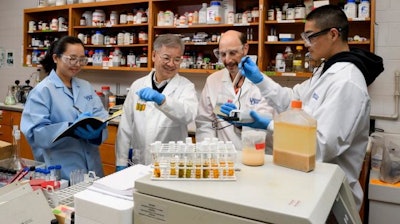 Engineering professors Daniel Cha (second from left) and Michael Chajes (third from left) work with students In-Young Kim (far left) and Gabe Chao to study samples taken from the food digester at Caesar Rodney Dining Hall.