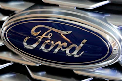 This Feb. 15, 2018, file photo shows a Ford logo on the grill of a car on display at the Pittsburgh Auto Show. Ford is recalling nearly 1.3 million Focus compact cars in the U.S. because a fuel system problem can cause the engines to stall without warning.