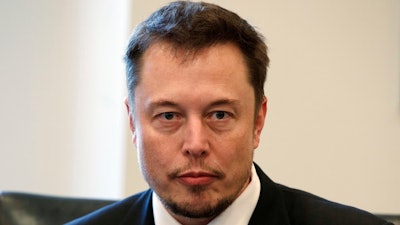 In this Dec. 14, 2016, file photo, Tesla CEO Elon Musk listens as President-elect Donald Trump speaks during a meeting with technology industry leaders at Trump Tower in New York. Electric carmaker Tesla must find a new chair for its board of directors under a settlement announced Saturday, Sept. 29, 2018, with the Securities and Exchange Commission. Whoever takes on the job will face the formidable task of overseeing Musk, a charismatic, visionary executive with an impulsive streak.