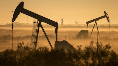 Fog blankets a low-lying area where pumpjacks operate in West Texas, northeast of Kermit, on Sept. 12, 2018. In December 2017, companies in the Permian Basin _ an ancient, oil-rich seabed that spans West Texas and southeastern New Mexico _ produced twice as much oil as they had four years earlier, during the last boom. Forecasters expect production to double again by 2023.