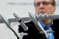 In this Dec. 13, 2011, file photo Microsoft co-founder Paul Allen looks across at a model of a giant airplane and spaceship he plans on building, during a news conference about the plane in Seattle. Prior to his death on Monday, Oct. 15, 2018, Allen invested large sums in technology ventures, research projects and philanthropies, some of them eclectic and highly speculative. Outside of bland assurances from his investment company, no one seems quite sure what happens now.