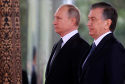 Russian President Vladimir Putin, left, and Uzbek President Shavkat Mirziyoyev look at honour guard soldiers in the presidential residence in Tashkent, Uzbekistan, on Friday, Oct. 19, 2018. Putin arrived in Uzbekistan on Friday for an official visit.