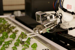 In this Thursday, Sept. 27, 2018, photo a robotic arm lifts plants being grown at Iron Ox, a robotic indoor farm, in San Carlos, Calif. At the indoor farm, robot farmers that roll maneuver through a suburban warehouse tending to rows of leafy, colorful vegetables that will soon be filling salad bowls in restaurants and eventually may be in supermarket produce aisles, too.