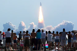 Crowds watch as the space shuttle Discovery lifts off from Kennedy Space Center in Cape Canaveral, Fla.