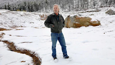 In this Oct. 11, 2018 photo, Paule Antonioli, an independent miner from Butte, stands among tailing piles at his Mammoth Mine south of Cardwell, Mont. in the Tobacco Root Mountains. Through a program that began in 2011, Barrick Gold Corp.-owned Golden Sunlight has paid out more than $45 million to small miners in the last seven years, company officials say. All of it has been for gold dug out of old mine dumps.