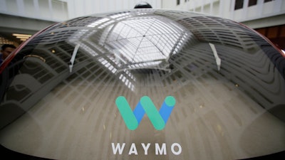 In this Dec. 13, 2016, file photo, a skylight is reflected in the rear window of a Waymo driverless car during a Google event in San Francisco. Google's robotic car spin-off Waymo is poised to become the first to test fully driverless vehicles on California's public roads.