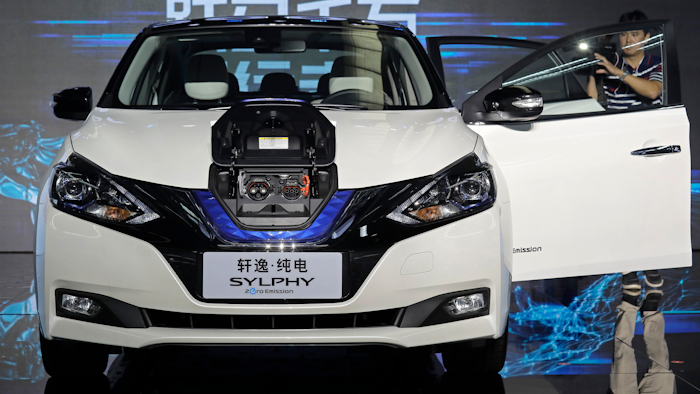 In this Aug. 27, 2018, file photo, a cameraman takes video of a Nissan Sylphy Zero Emission, the Nissan's first all-electric vehicle built in China, at the Nissan factory in Guangzhou, Guangdong province, China. More than 200 manufacturers, including Tesla, Volkswagen, BMW, Daimler, Ford, General Motors, Nissan, Mitsubishi and U.S.-listed electric vehicle start-up NIO, transmit position information and dozens of other data points to government-backed monitoring centers, The Associated Press has found. Generally, it happens without car owners' knowledge.