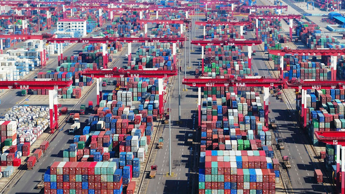 Containers are piled high at a port in Qingdao in eastern China's Shandong province Thursday, Nov. 8, 2018. Growth in Chinese exports to the United States ticked up in October as traders rushed to beat another round of tariff hikes.