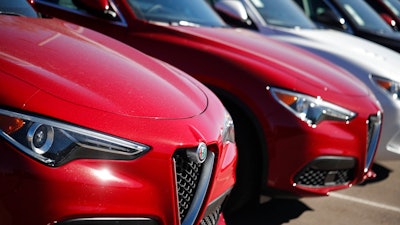 In this Oct. 21, 2018, file photo a long line of unsold 2018 Stelvio sports-utility vehicles sits at an Alfa Romeo dealership in Highlands Ranch, Colo. On Wednesday, Nov. 21, the Commerce Department releases its October report on durable goods.