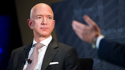 In this Sept. 13, 2018, file photo Jeff Bezos, Amazon founder and CEO, speaks at The Economic Club of Washington's Milestone Celebration in Washington. Amazon expects to begin recruiting next year for software developers, accountant, executives, managers, and human resources professionals for its new hubs in New York’s Long Island City and the Washington suburb of Arlington. The employees will be hired over several years as Amazon seeks talent to support an empire that has expanded beyond retail to include cloud computing services, advertising and, video streaming and TV production.