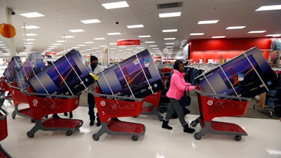 Thanksgiving Day holiday shoppers line up with television sets on discount at the Target retail store in Chicago, Illinois, in 2013.