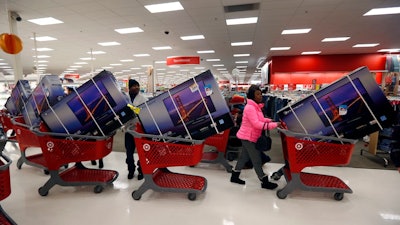 Thanksgiving Day holiday shoppers line up with television sets on discount at the Target retail store in Chicago, Illinois, in 2013.