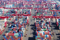 Containers are piled high at a port in Qingdao in eastern China's Shandong province Thursday, Nov. 8, 2018. Growth in Chinese exports to the United States ticked up in October as traders rushed to beat another round of tariff hikes.