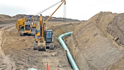 In this Oct. 5, 2016, file photo, heavy equipment is seen at a site where sections of the Dakota Access pipeline were being buried near the town of St. Anthony in Morton County, N.D. The Standing Rock Sioux is challenging new government conclusions that the $3.8 billion Dakota Access oil pipeline poses no significant environmental threats to American Indian tribes in the Dakotas. The Army Corps of Engineers in August finished more than a year of additional study ordered by a federal judge.