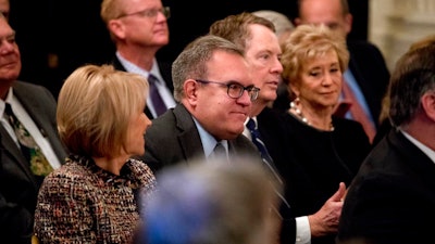 EPA acting Administrator Andrew Wheeler, smiles as he is recognized by President Donald Trump during a Medal of Freedom ceremony in the East Room of the White House in Washington, Friday, Nov. 16, 2018. Also pictured is Education Secretary Betsy DeVos, left, and U.S. Trade Representative Robert Lighthizer, second from right. Wheeler, a former congressional aide and lobbyist who has led the EPA since his scandal-plagued predecessor resigned earlier this year, got Trump's nod for the permanent job. Trump made the announcement in passing at a White House ceremony for Presidential Medal of Freedom honorees.