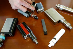 In this Tuesday, April 10, 2018, file photo, a high school principal displays vaping devices that were confiscated from students in such places as restrooms or hallways at the school in Massachusetts. The Food and Drug Administration is planning on requiring strict limits on the sale of most flavored e-cigarettes, including age verification controls for online sales, in an effort to curtail their use among children and teenagers. FDA officials tell The Wall Street Journal on Thursday, Nov. 8, the actions are expected to be announced as early as the following week.