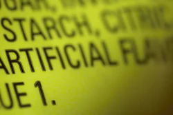 This photo shows part of an ingredient label, which lists 'artificial flavoring,' on a packet of candy. The U.S. Food and Drug Administration has decided to give companies two years to purge their products of the six ingredients, described only as “artificial flavors” on packages.