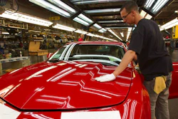 In this June 10, 2011, file photo, a worker checks the paint on a Camaro at the GM factory in Oshawa, Ontario. General Motors is closing a Canadian plant at the cost of about 2,500 jobs, but that is apparently just a piece of a much broader, company-wide restructuring that will be announced as early as Monday, Nov. 26, 2018.