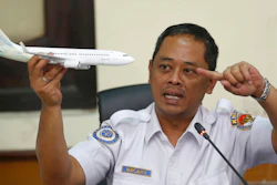 National Transportation Safety Committee investigator Nurcahyo Utomo holds a model of an airplane during a press conference on the committee's preliminary findings on their investigation on the crash of Lion Air flight 610, in Jakarta, Indonesia, Wednesday, Nov. 28, 2018. Black box data collected from their crashed Boeing 737 MAX 8 show Lion Air pilots struggled to maintain control as the aircraft's automatic safety system repeatedly pushed the plane's nose down, according to a preliminary investigation into last month's disaster.