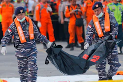 In this Thursday, Nov. 1, 2018, file photo, navy personnel carry the remains of a victim of Lion Air jet that crashed into the sea at the Tanjung Priok Port in Jakarta, Indonesia. Boeing Co. says it has issued a safety bulletin that reiterates guidelines on how pilots should respond to erroneous data from an 'angle of attack' sensor following last week's crash of a Boeing plane in Indonesia that killed 189 people.