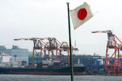 In this Aug. 24, 2018, photo, a Japanese flag is hoisted near the pier of a container terminal in Tokyo. Japan recorded a trade deficit in October but a recovery in exports after getting slammed by natural disasters in September, according to government data released Monday, Nov. 19, 2018. Exports grew 8.2 percent from the same month the previous year, the Finance Ministry said.