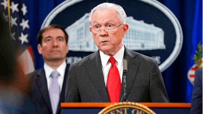 Attorney General Jeff Sessions speaks during a news conference to announce a criminal law enforcement action involving China, at the Department of Justice in Washington, Thursday, Nov. 1, 2018. Standing behind Sessions is Assistant Attorney General for National Security John C. Demers. The Justice Department and FBI leaders announced criminal charges and an operation to thwart Chinese economic espionage.