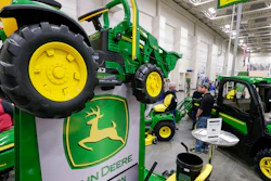 In this Feb. 23, 2018 file photo, John Deere products, including a toy tractor on the sign, are on display at the 'Spring into Spring' home and garden trade show in Council Bluffs, Iowa, John Deere, the maker of agricultural and construction equipment, reported a 46 percent boost in profit to $784.8 million, or $2.42 per share. But earnings, adjusted for pretax gains, came to $2.30 per share, 14 cents short of industry analyst projections, according to a survey by Zacks Investment Research.