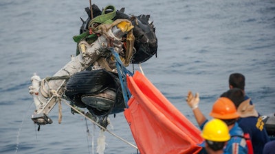 Rescuers use crane to retrieve part of the landing gears of the crashed Lion Air jet from the sea floor in the waters of Tanjung Karawang, Indonesia, Sunday, Nov. 4, 2018. Investigators succeeded in retrieving hours of data from the aircraft's flight recorder as Indonesian authorities on Sunday extended the search at sea for victims and debris.