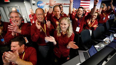 Engineers celebrate as the InSight lander touch downs on Mars in the mission support area of the space flight operation facility at NASA's Jet Propulsion Laboratory Monday, Nov. 26, 2018, in Pasadena, Calif.