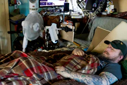In this Friday, Nov. 16, 20158 photo, Jim Taft watches The History Channel from the confines of his bed at his home in West Columbia, S.C. Taft has experienced debilitating health issues after a neurosurgeon implanted Boston Scientific's Precision spinal cord stimulator in his back in 2014.