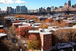 The Queensbridge Houses sit beneath the Ed Koch Queensboro Bridge, upper right, Friday, Nov. 16, 2018, in New York. Like most New York City housing projects, Queensbridge residents complain of poor conditions, lacking heat or hot water, or rats and roaches. The city has come under sharp criticism for the conditions of its public housing. Amazon is proposing to build a new headquarters nearby.