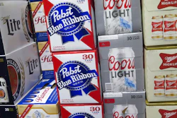 In this photo taken on Thursday, Nov. 8, 2018, cases of Pabst Blue Ribbon and Coors Light are stacked next to each other in a Milwaukee liquor store. Pabst Brewing Company and MillerCoors are heading to trial starting Monday, Nov. 12, to settle a contract dispute in which Pabst accuses the brewing giant of trying to undermine its competitor by breaking a contract to make their products.