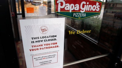 A sign posted on the door of a Papa Gino's Pizzeria location in Marlborough, MA states that it is now closed.