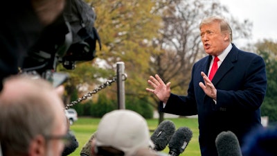 In this Nov. 26, 2018, photo, President Donald Trump speaks to members of the media before boarding Marine One on the South Lawn of the White House in Washington. Trump has moved steadily to dismantle Obama administration efforts to rein in coal, oil and gas emissions, even as warnings grow _ from his own administration and others _ about the devastating impact of climate change on the U.S. economy as well as the earth. Trump has dismissed his administration’s warnings about the impact of climate change, including a forecast, released Friday, that it could lead to economic losses of hundreds of billions of dollars by the end of the century.