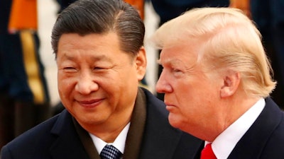 In this Nov. 9, 2017, file photo, U.S. President Donald Trump and Chinese President Xi Jinping participate in a welcome ceremony at the Great Hall of the People in Beijing, China. Xi had an 'extremely positive' phone conversation with Trump about trade and other issues, the foreign ministry said Friday, Nov. 2, 2018. The two leaders agreed to 'strengthen economic exchanges,' said a ministry spokesman, Lu Kang.