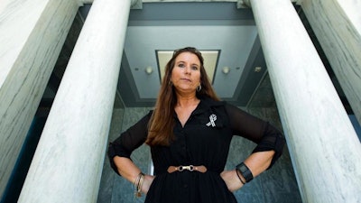 Jamee Cook poses for a photo at Rayburn House Office Building after meeting with congressional leaders on Capitol Hill, Thursday, Sept. 6, 2018, in Washington. Cook had breast implants that ruptured and which she believes caused her medical problems. She now is lobbying the FDA and congressional leaders to do a better job of tracking and regulating medical devices.