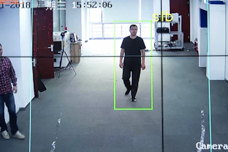 In this Oct. 31, 2018, photo, Huang Yongzhen, CEO of Watrix, demonstrates the use of his firm's gait recognition software at his company's offices in Beijing. A Chinese technology startup hopes to begin selling software that recognizes people by their body shape and how they walk, enabling identification when faces are hidden from cameras. Already used by police on the streets of Beijing and Shanghai, “gait recognition” is part of a major push to develop artificial-intelligence and data-driven surveillance across China, raising concern about how far the technology will go.