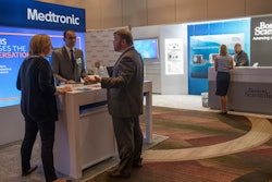 In this Saturday, Aug. 25, 2018 photo, sales representatives for Medtronic and Boston Scientific work their booths at the NYC Neuromodulation Conference in New York.