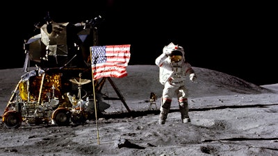 In this April 1972 photo made available by NASA, John Young salutes the U.S. flag at the Descartes landing site on the moon during the first Apollo 16 extravehicular activity. America's next moon landing will be made by private companies, not NASA. NASA Administrator Jim Bridenstine announced Thursday, Nov. 29, 2018, that nine U.S. companies will compete in delivering experiments to the lunar surface.