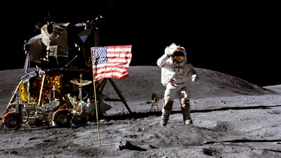 In this April 1972 photo made available by NASA, John Young salutes the U.S. flag at the Descartes landing site on the moon during the first Apollo 16 extravehicular activity. America's next moon landing will be made by private companies, not NASA. NASA Administrator Jim Bridenstine announced Thursday, Nov. 29, 2018, that nine U.S. companies will compete in delivering experiments to the lunar surface.