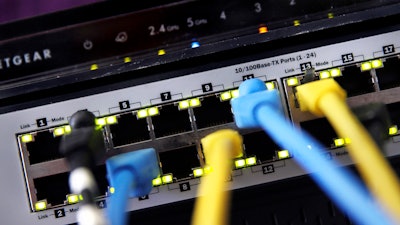 In this June 19, 2018, file photo a router and internet switch are displayed in East Derry, N.H. Net neutrality traces back to an engineering maxim called the “end-to-end principle,” a self-regulating network that put control in the hands of end users rather than a central authority. Traditional cable-TV services, for instance, required special equipment and controlled what channels are shown on TV. With an end-to-end network like the internet, the types of equipment, apps, articles and video services permitted are limited only to imagination.