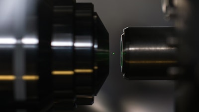 A silica sphere with a radius of 50 nanometers is trapped levitating in a beam of light.