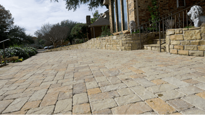 This Nov. 24, 2018 photo shows a stone pavers driveway in a residential neighborhood in Dallas, Texas. One driveway at a time, many homeowners and communities are opting for permeable paving options instead of traditional asphalt.