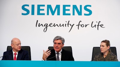Siemens CEO Joe Kaeser, center, briefs the media flanked by CFO Ralf P. Thomas, left, and head of communications Clarissa Haller, right, during the annual press conference of the company in Munich, Germany, Thursday, Nov. 8, 2018.