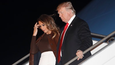 President Donald Trump and first lady Melania Trump walk from Air Force One, Thursday, Nov. 29, 2018, as they arrive at the Ministro Pistarini international airport in Buenos Aires, Argentina. Trump traveled to Argentina to attend the G20 summit.