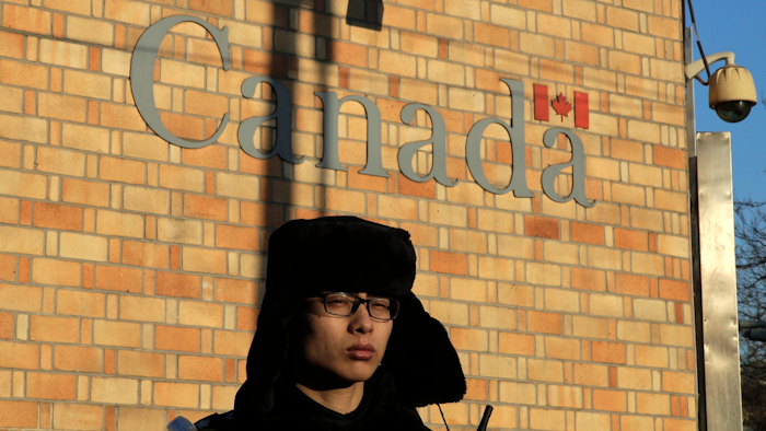 A policeman stands watch outside the Canadian Embassy in Beijing.