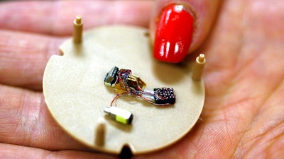 A woman holds a hearing aid that uses artificial intelligence in Somerset, N.J. The challenges of making the technology industry a more welcoming place for women are numerous, especially in the booming field of artificial intelligence.