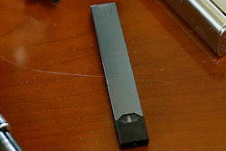 This April 10, 2018, file photo shows a Juul in Marshfield, Mass. Altria is spending $12.8 billion for a stake in e-vapor company JUUL as one of the world’s biggest tobacco companies tries to offset declining cigarette use.