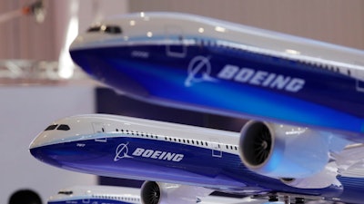 In this Nov. 6, 2018, file photo models of a Boeing passenger airliner are displayed during the 12th China International Aviation and Aerospace Exhibition, also known as Airshow China 2018, in Zhuhai city, south China's Guangdong province. Boeing is buying a majority stake in Embraer’s commercial aircraft and services operations for $4.2 billion. The joint venture announced Monday, Dec. 17, gives Boeing 80 percent ownership of those operations, with Embraer owning the remaining stake.
